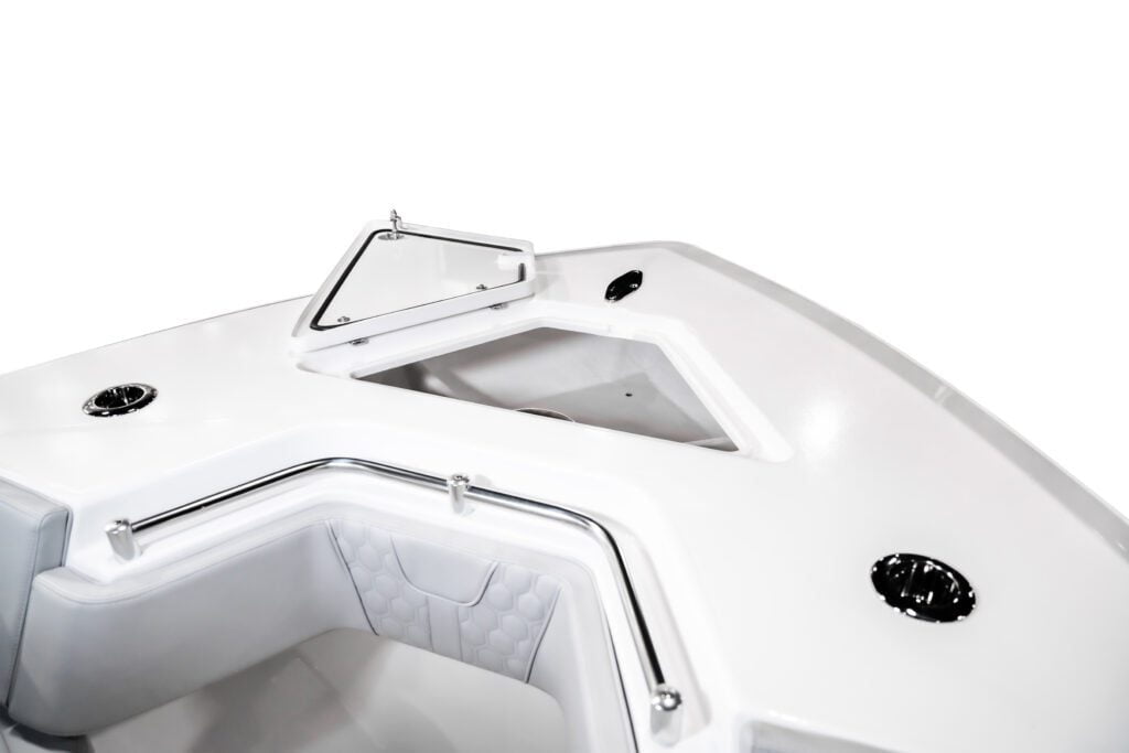 Top view of a boat bow with white cushioned seats, chrome handrails, and open storage compartments.