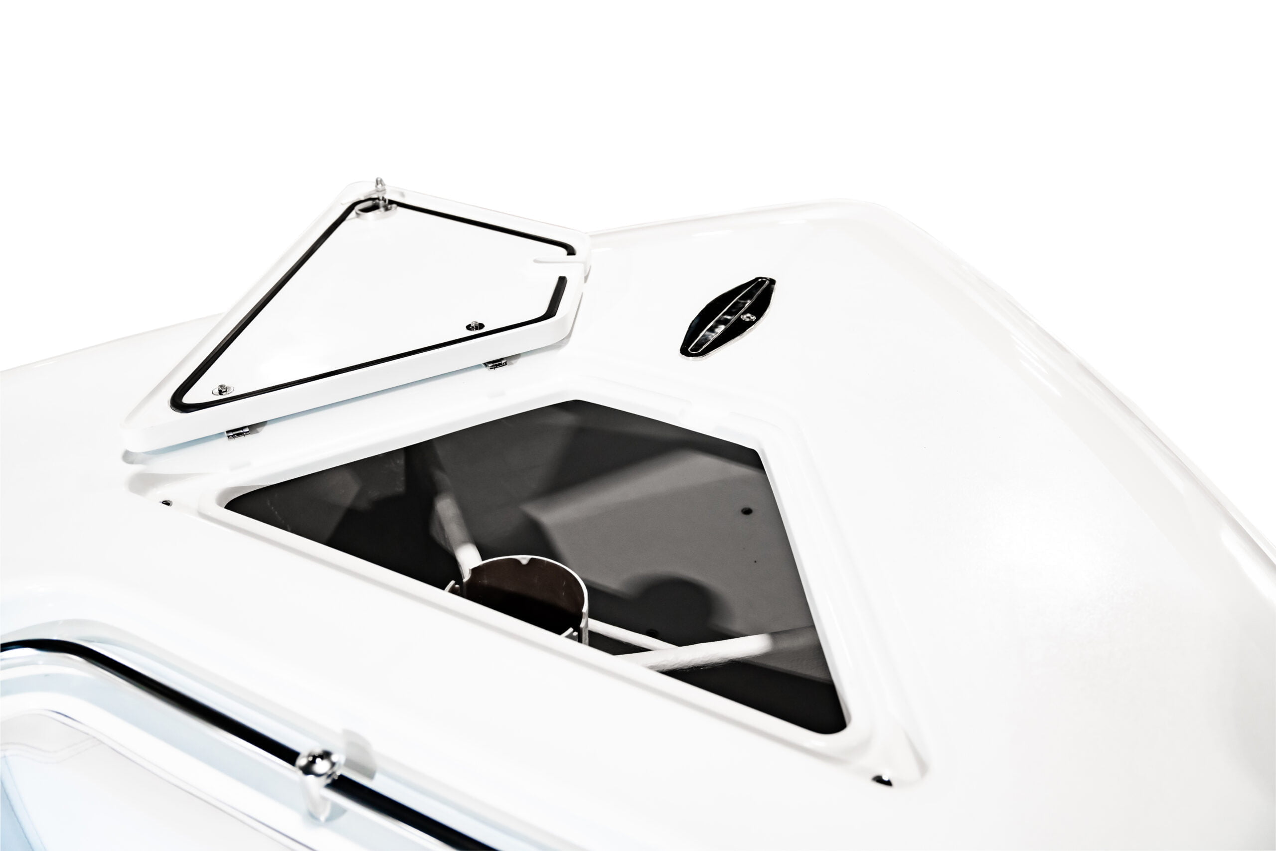 Close-up image of an open hatch on the deck of a white boat, showing the interior space beneath it.