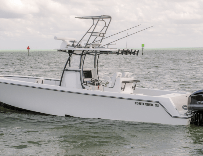 A white Contender fishing boat is seen floating in calm waters, equipped with fishing rods and a Yamaha outboard motor.