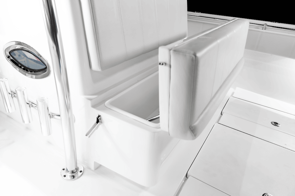 White boat interior featuring a cushioned foldable seat, storage compartment underneath, metal rod holders, and a small window on the side.